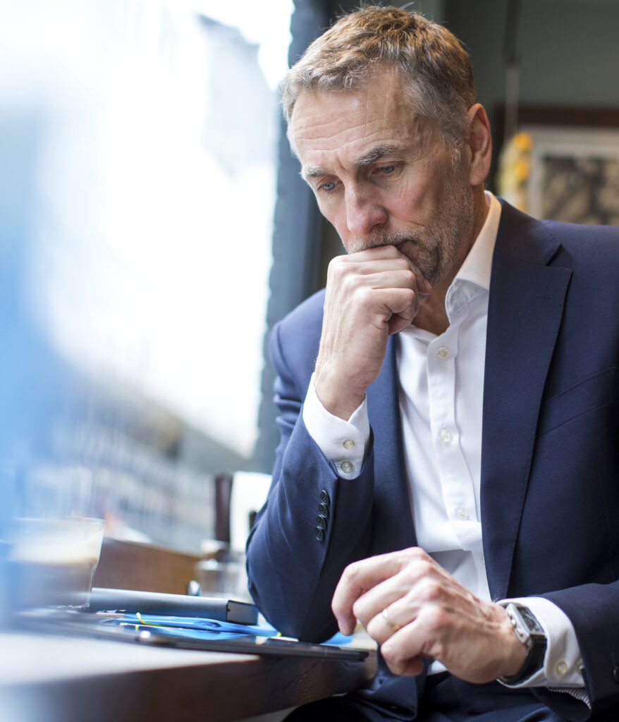 Professional male researching retraining after 50 in the UK.