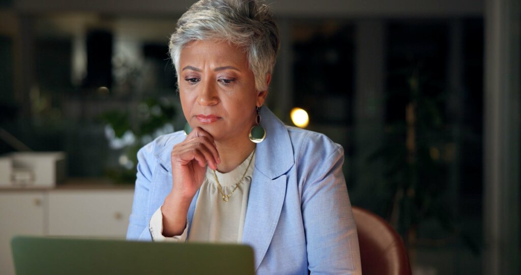 Attractive woman studying options for retraining after 50 in the UK.
