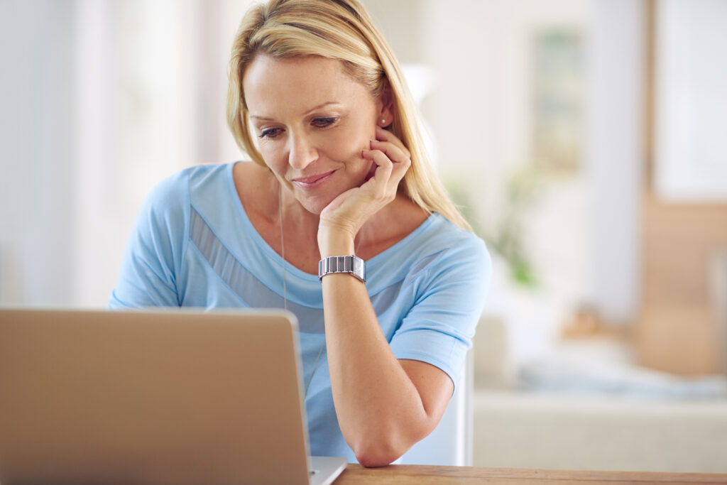 Professional over 50 reflecting on career change at desk